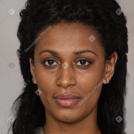 Joyful black young-adult female with long  black hair and brown eyes