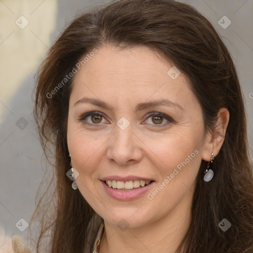 Joyful white adult female with long  brown hair and grey eyes