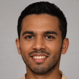 Joyful latino young-adult male with short  black hair and brown eyes