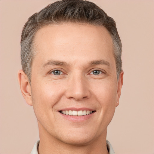 Joyful white adult male with short  brown hair and brown eyes