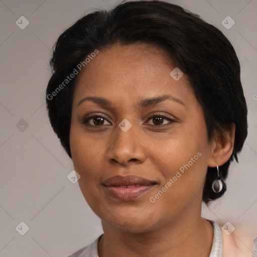 Joyful black adult female with medium  brown hair and brown eyes