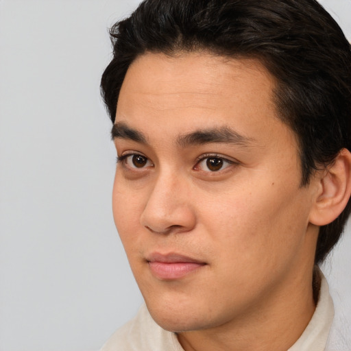 Joyful white young-adult male with short  black hair and brown eyes