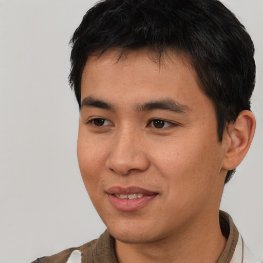 Joyful asian young-adult male with short  black hair and brown eyes