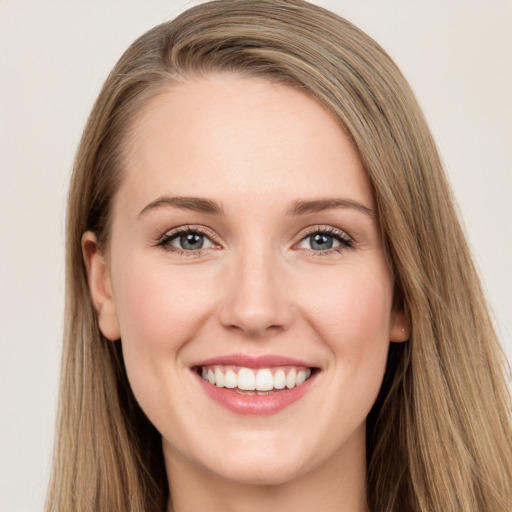 Joyful white young-adult female with long  brown hair and green eyes