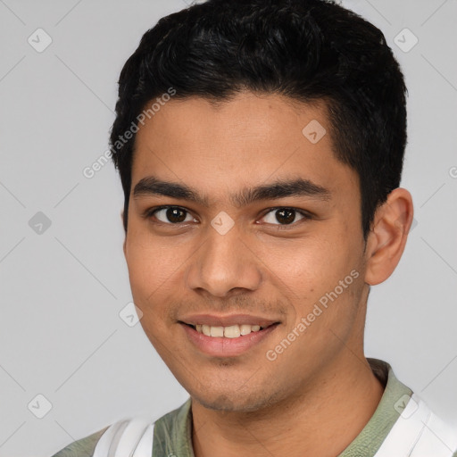 Joyful white young-adult male with short  black hair and brown eyes