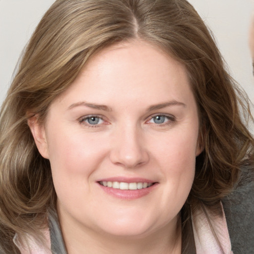 Joyful white young-adult female with medium  brown hair and blue eyes