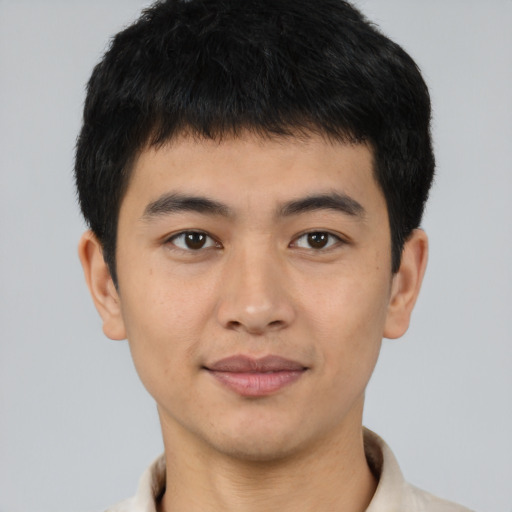 Joyful latino young-adult male with short  brown hair and brown eyes
