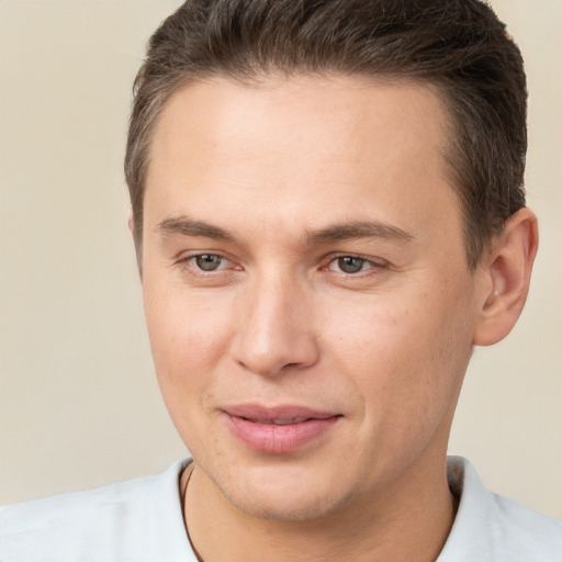 Joyful white young-adult male with short  brown hair and brown eyes