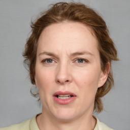 Joyful white adult female with medium  brown hair and blue eyes