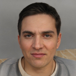 Joyful white adult male with short  brown hair and brown eyes