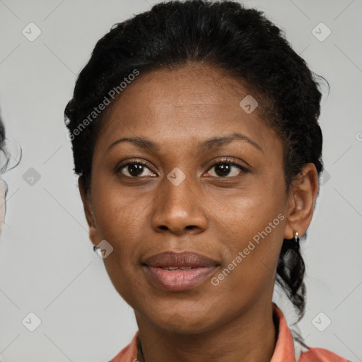 Joyful black adult female with short  brown hair and brown eyes