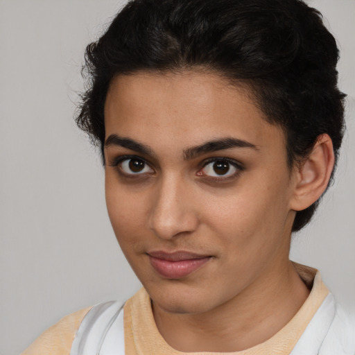 Joyful latino young-adult female with short  brown hair and brown eyes