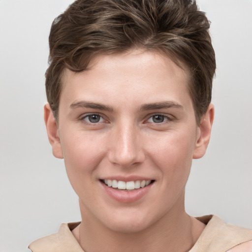 Joyful white young-adult female with short  brown hair and grey eyes