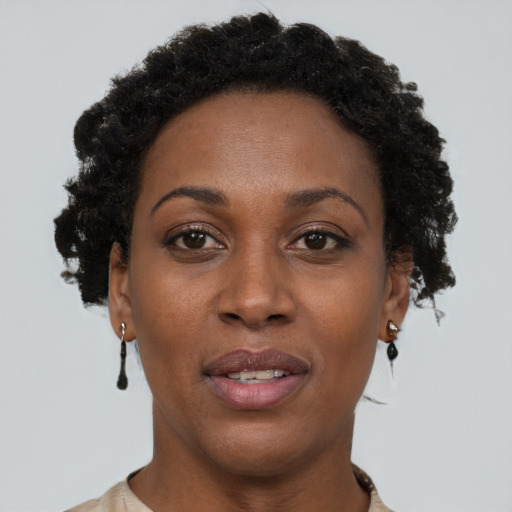 Joyful black adult female with short  brown hair and brown eyes
