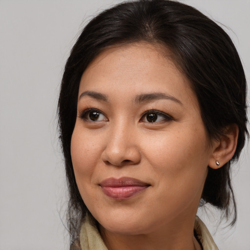Joyful asian young-adult female with medium  brown hair and brown eyes