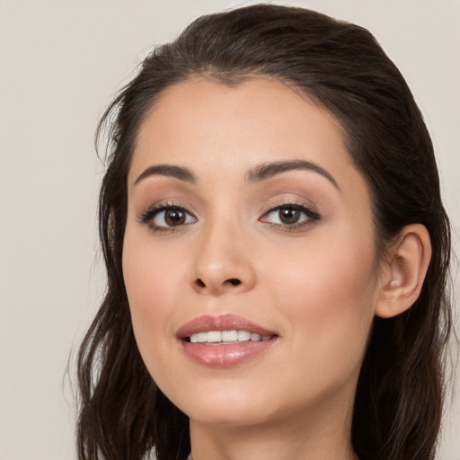 Joyful white young-adult female with long  brown hair and brown eyes