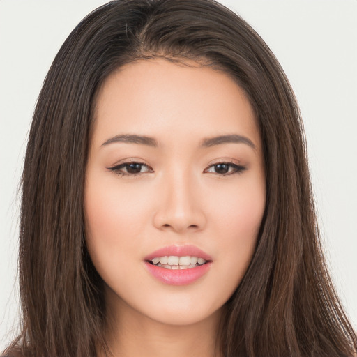 Joyful asian young-adult female with long  brown hair and brown eyes