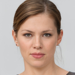 Joyful white young-adult female with medium  brown hair and grey eyes