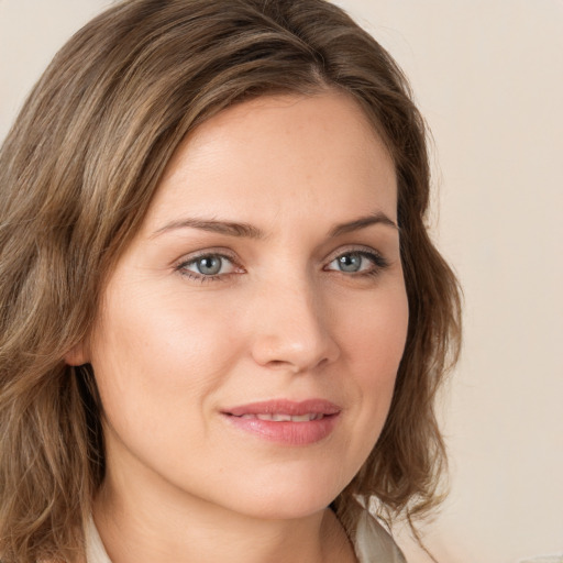 Joyful white young-adult female with long  brown hair and green eyes