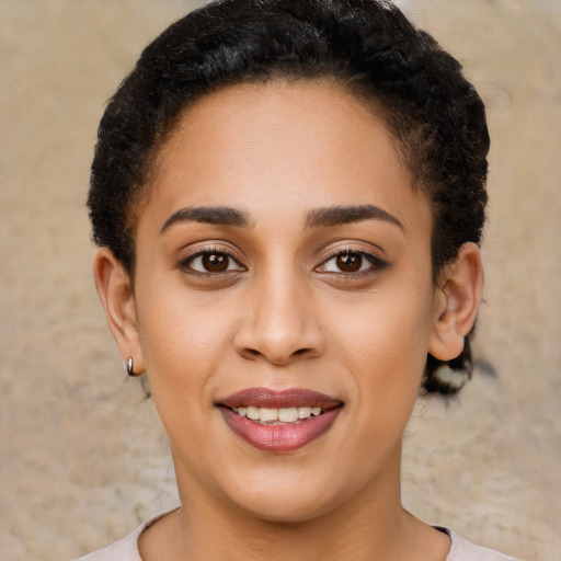 Joyful latino young-adult female with short  brown hair and brown eyes