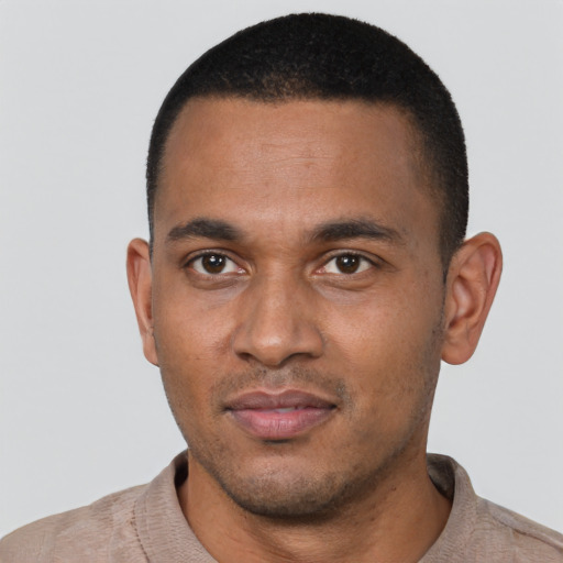 Joyful black young-adult male with short  black hair and brown eyes