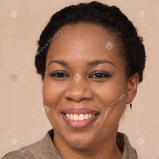 Joyful black adult female with short  brown hair and brown eyes