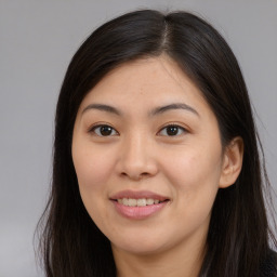 Joyful asian young-adult female with long  brown hair and brown eyes