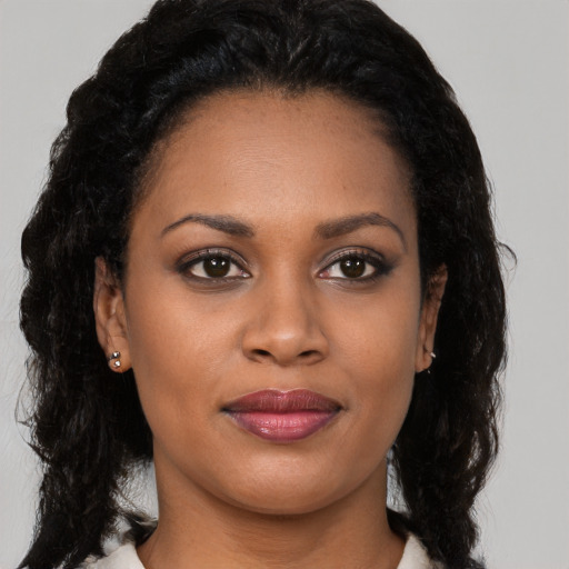Joyful black young-adult female with medium  black hair and brown eyes