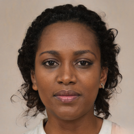 Neutral black young-adult female with medium  brown hair and brown eyes