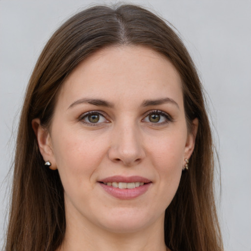 Joyful white young-adult female with long  brown hair and grey eyes