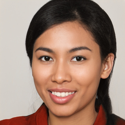 Joyful latino young-adult female with medium  black hair and brown eyes