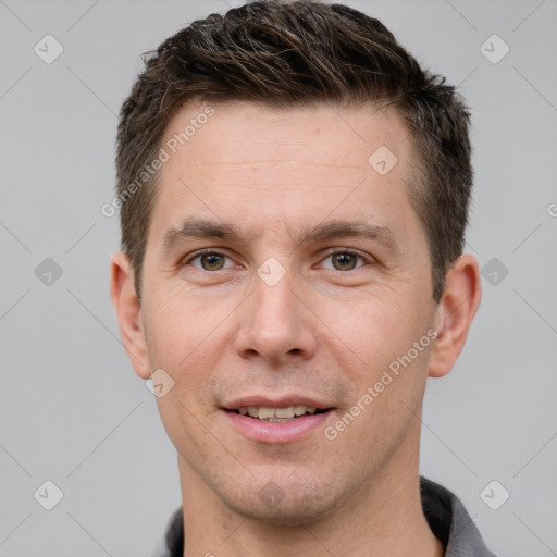 Joyful white adult male with short  brown hair and grey eyes