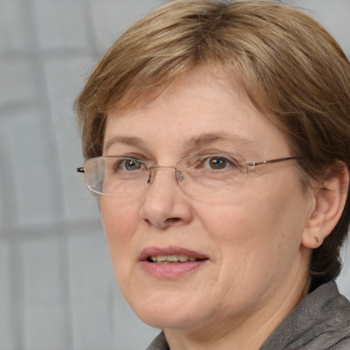 Joyful white adult female with short  brown hair and blue eyes