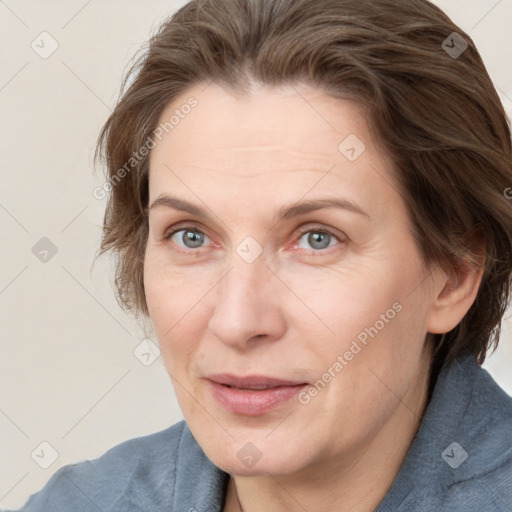 Joyful white adult female with medium  brown hair and grey eyes