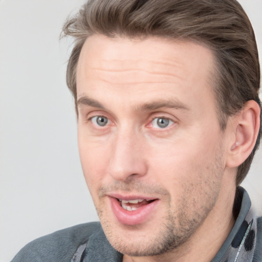 Joyful white adult male with short  brown hair and grey eyes