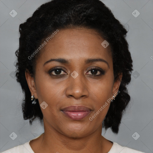 Joyful black adult female with medium  brown hair and brown eyes