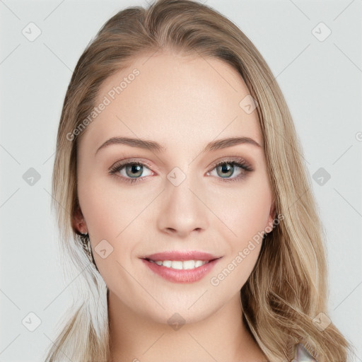 Joyful white young-adult female with long  brown hair and blue eyes