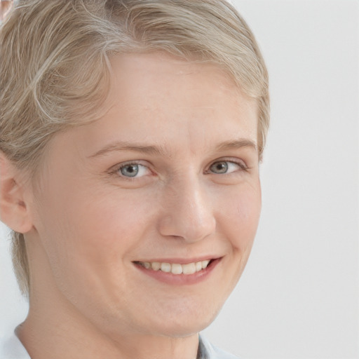 Joyful white young-adult female with short  blond hair and grey eyes