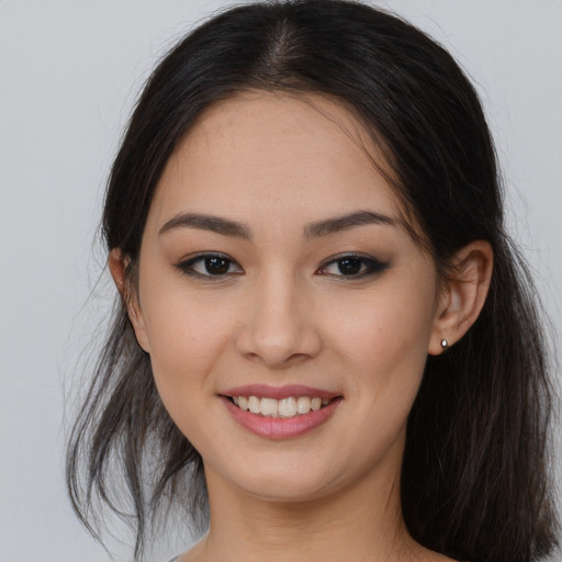 Joyful asian young-adult female with long  brown hair and brown eyes