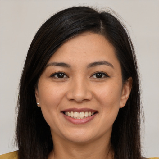 Joyful latino young-adult female with long  brown hair and brown eyes