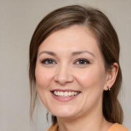 Joyful white young-adult female with medium  brown hair and brown eyes