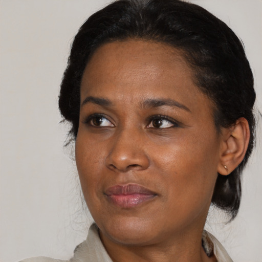 Joyful black adult female with medium  black hair and brown eyes