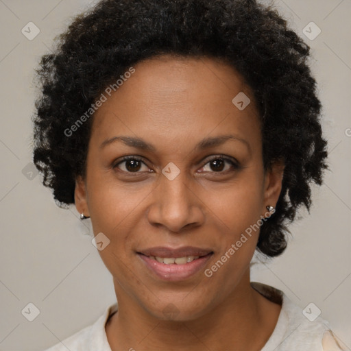 Joyful black adult female with short  brown hair and brown eyes