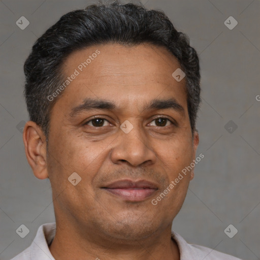 Joyful latino adult male with short  brown hair and brown eyes