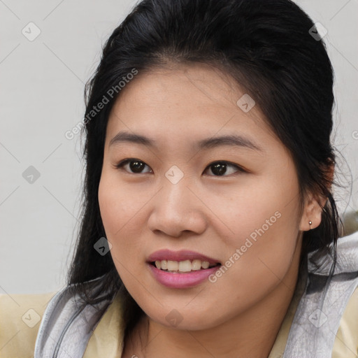 Joyful asian young-adult female with medium  brown hair and brown eyes