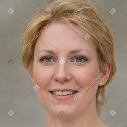 Joyful white adult female with medium  brown hair and blue eyes