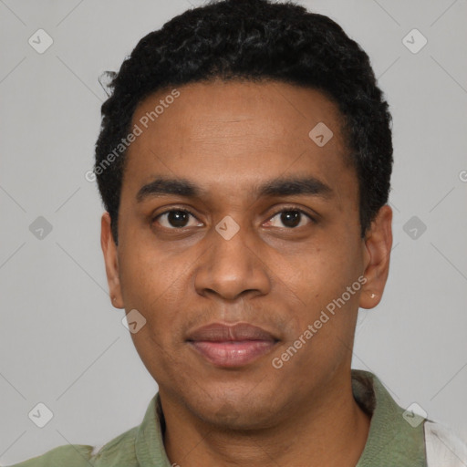 Joyful black young-adult male with short  black hair and brown eyes