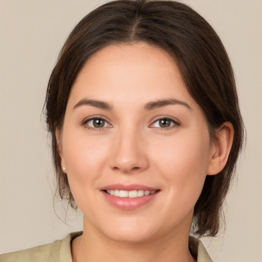 Joyful white young-adult female with medium  brown hair and brown eyes