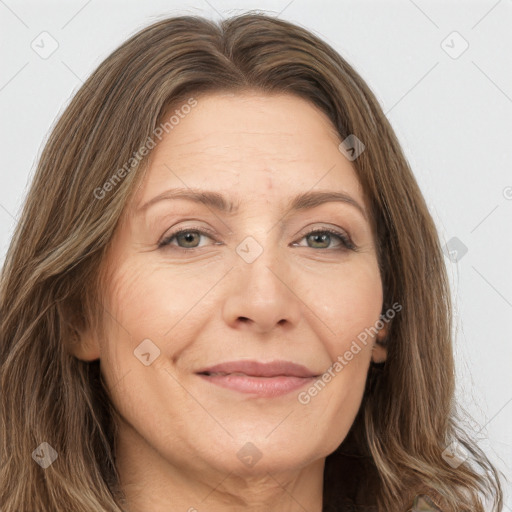 Joyful white adult female with long  brown hair and brown eyes