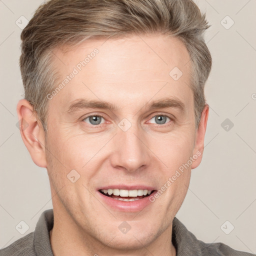 Joyful white adult male with short  brown hair and grey eyes